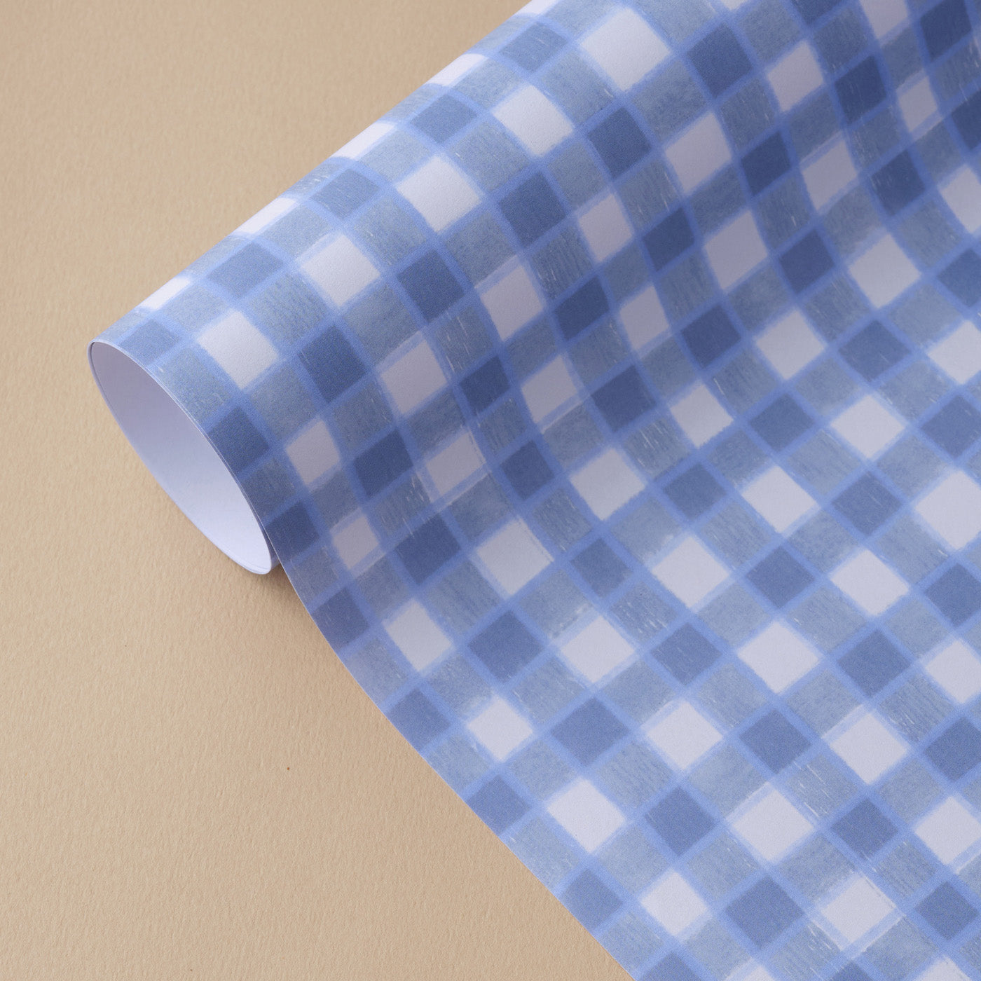 Wrapping paper sheet designed by Claire Paul with a playing blue gingham pattern on a white background. Each sheet measures 50 x 70cm 