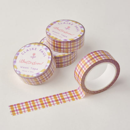 Stack of Pastel Gingham washi tapes in their packaging with an open roll. Tapes feature a lilac, pink and yellow gingham pattern. Each roll measures 15mm wide and has 10m of tape. Made by Claire Paul. 