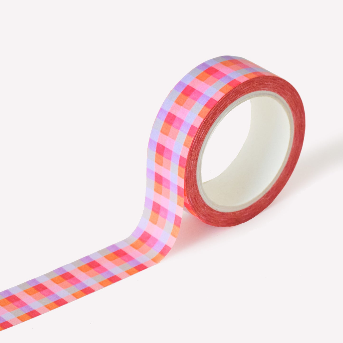 Roll of washi tape designed by Claire Paul, featuring a hand drawn gingham pattern in lilac, pink and orange. Each roll measures 15mm wide and has 10m of tape. 