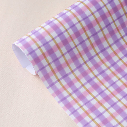 Wrapping paper sheet designed by Claire Paul featuring a pastel gingham pattern in lilac and pink. Each sheet measures 50 x 70 cm. 