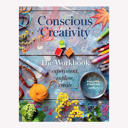 Book Cover titled “Conscious Creativity: The Workbook” by Philippa Stanton. Cover image features a painted table flatly with materials art materials and colourful foliage. 