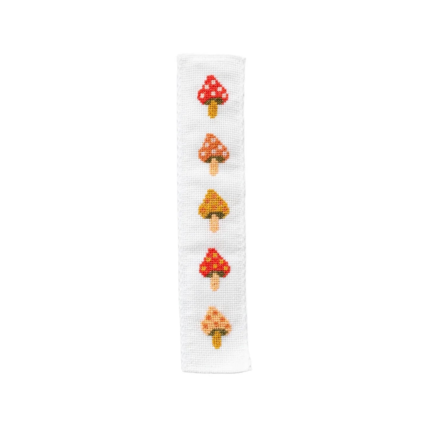 A finished cross-stitched bookmark with five red, orange and yellow coloured mushrooms.