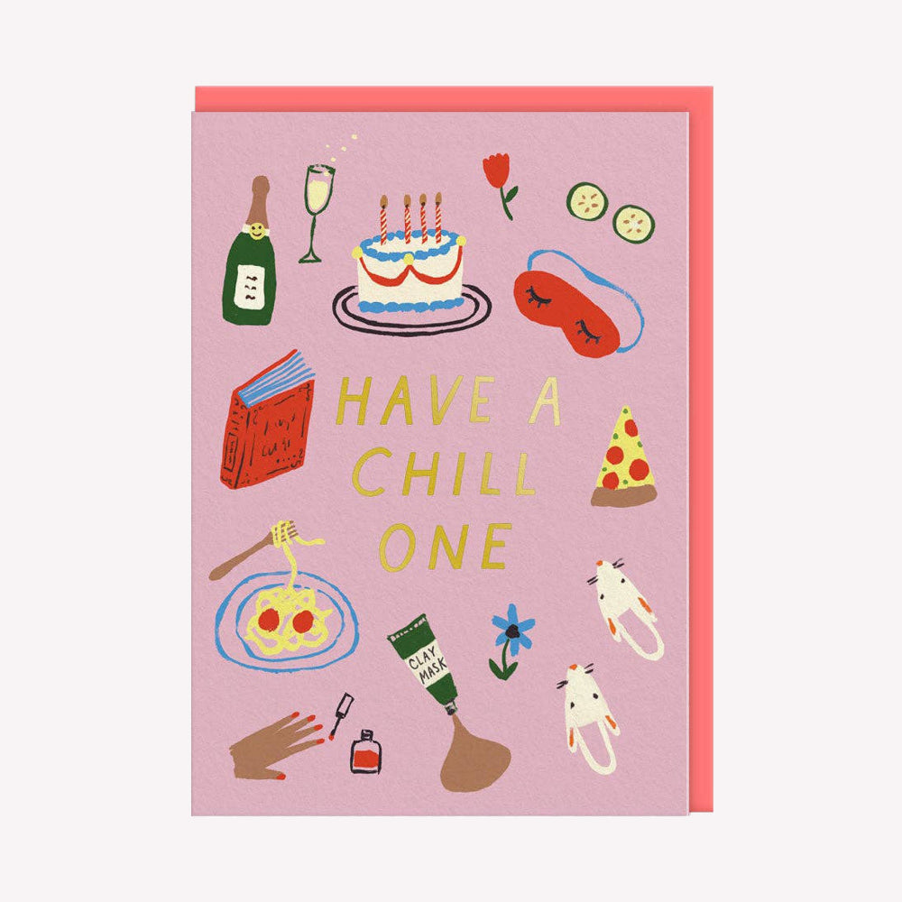 An illustrated birthday card by Emily Doliner, printed by Ohh Deer. This card features illustrations of a cake, slippers, nail varnish and a book, with text in the center that reads “Have A Chill One”.