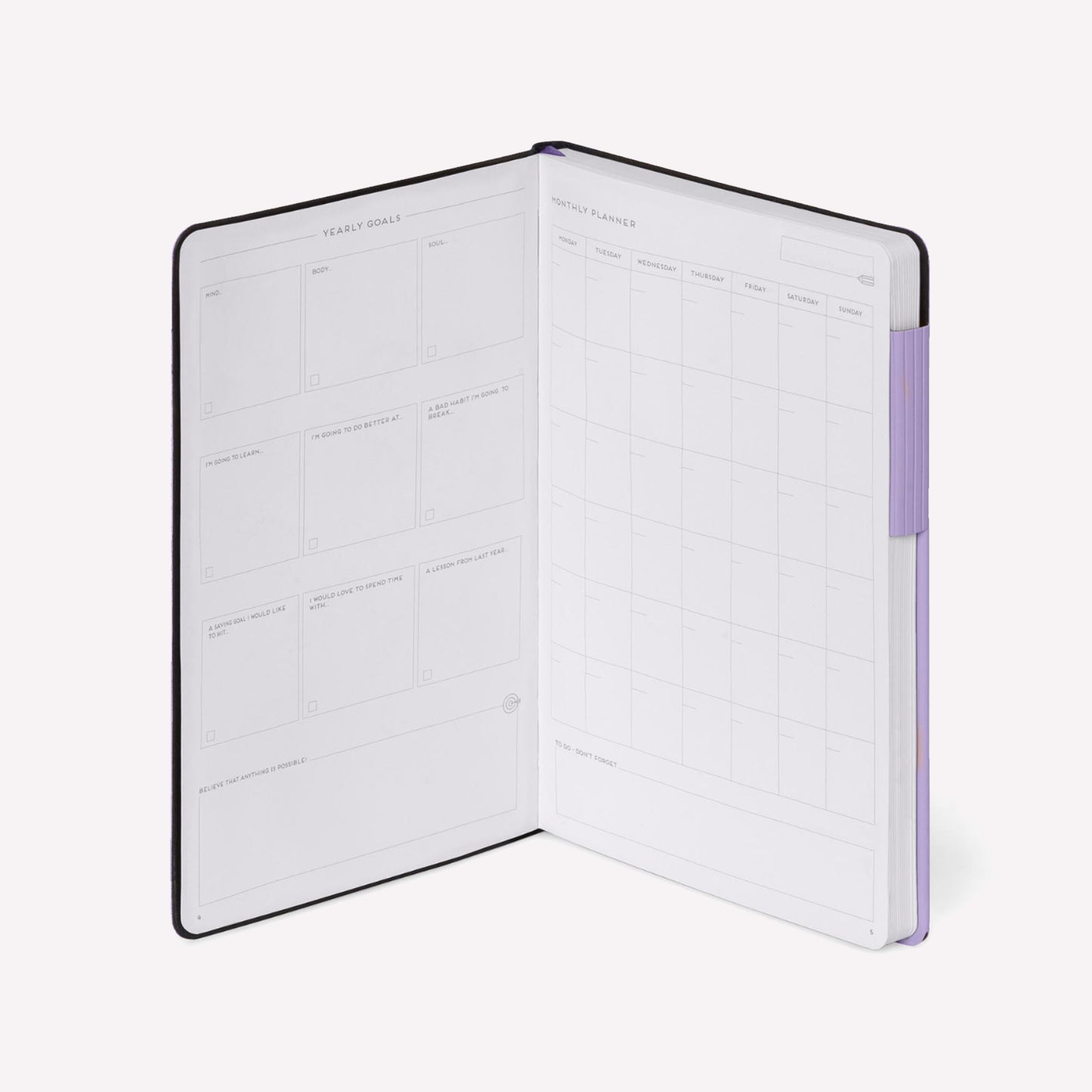 Legami "my notebook" dotted bullet journal with lavender cover open to show yearly goal tracker and monthly planner. 