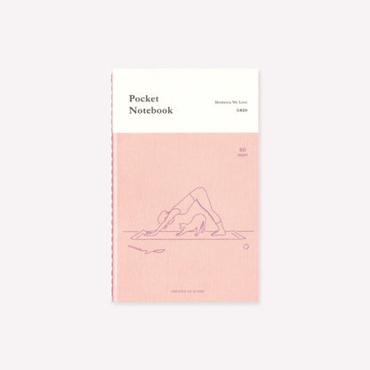 A pink and white 'Yoga' design stitch-bound pocket notebook by Korean stationery brand Iconic, featuring a person and their cat in the downward dog position. Text on the front of the notebook indicates 80 gridded pages inside.