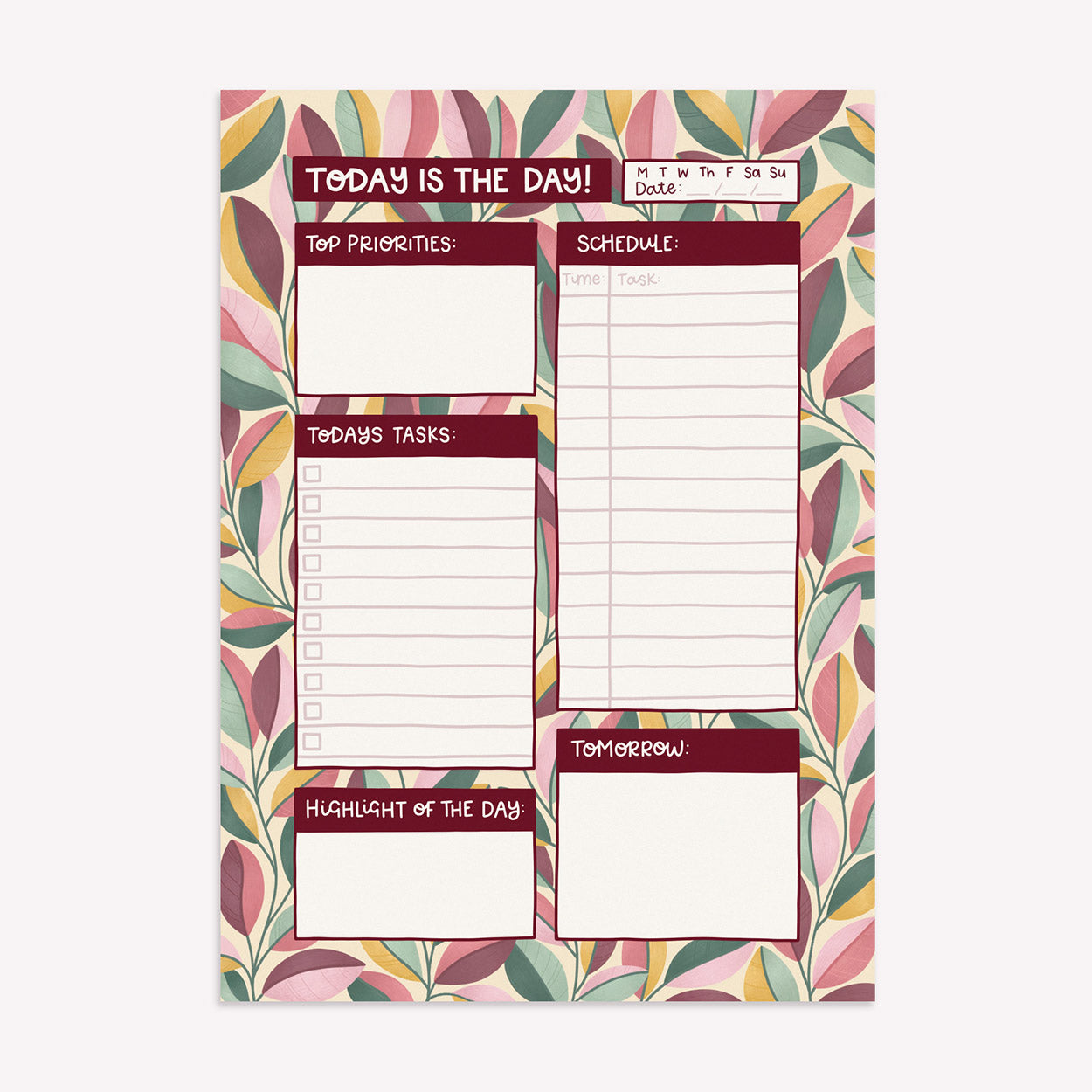 Nyassa Hinde Illustration Today is the Day daily desk planner with a pattern of coral, green and yellow leaves, room to write daily tasks, a schedule and priorities for the day. 