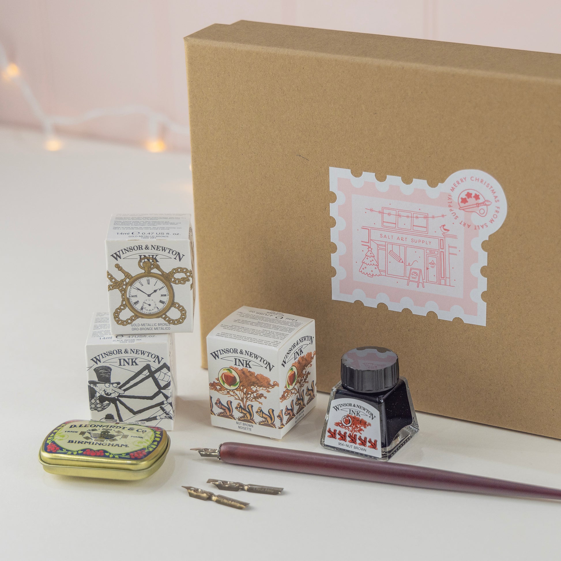 Salt Art Supply, Calligraphy for Beginners gift set including three drawing inks, a dip pen, calligraphy nibs and a nib storage tin, packaged in a festive branded box for Christmas gifting. 