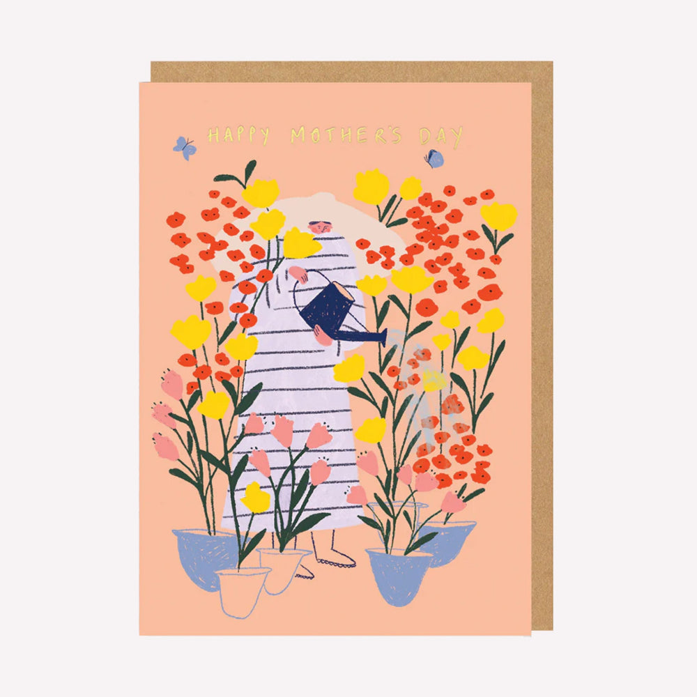 An illustrated Mother's Day card by Ohh Deer. This card features an illustration of a woman watering plants in a garden, with text above that reads “Happy Mother's Day”.