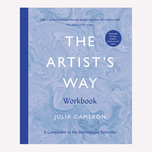 The Artist's Way workbook by Julia Cameron, with a blue marbled cover and royal blue spine. This book offers a structured course for those looking to reignite their creative spark. 