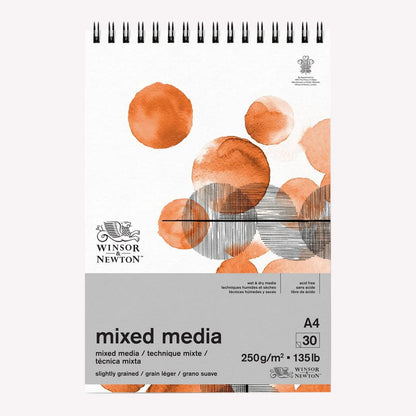 Winsor & Newton's Mixed Media Paper Pad in A4. Cover features a circular design painted with watercolour paints and pen and ink.